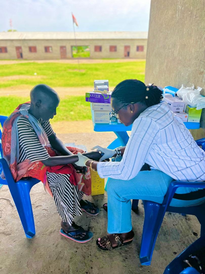 ARDF health worker providing primary care to a patient at a health facility